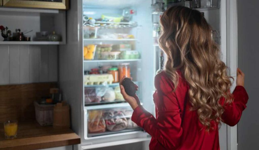 Persona con frigo aperto